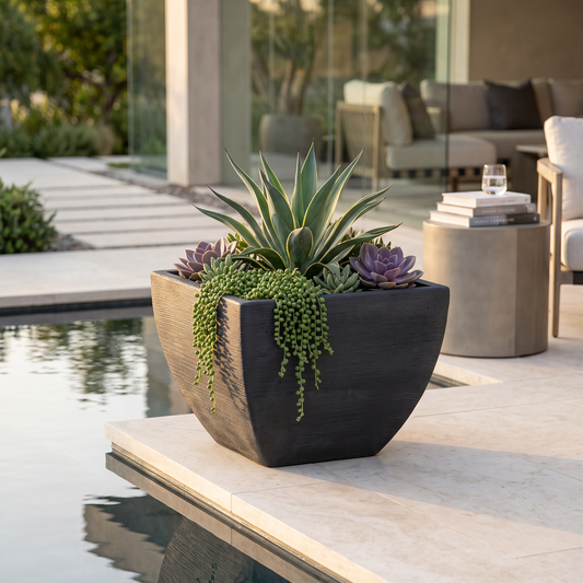 Solen Garden | Modern Lightweight Outdoor Planters LUMEN 140 square resin planter with matte stone texture by a pool.